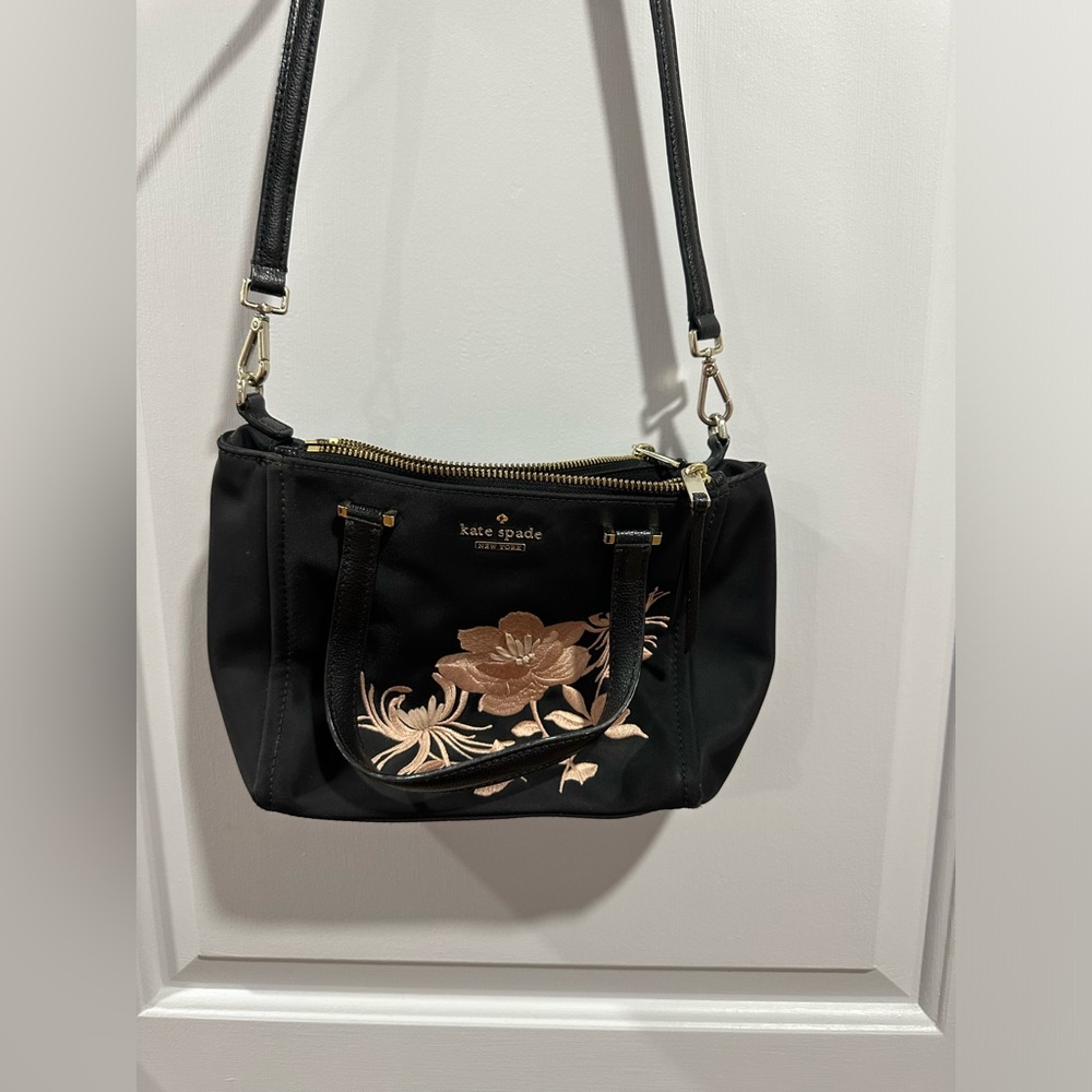 Kate spade black crossbody bag with pink flowers and lots of storage